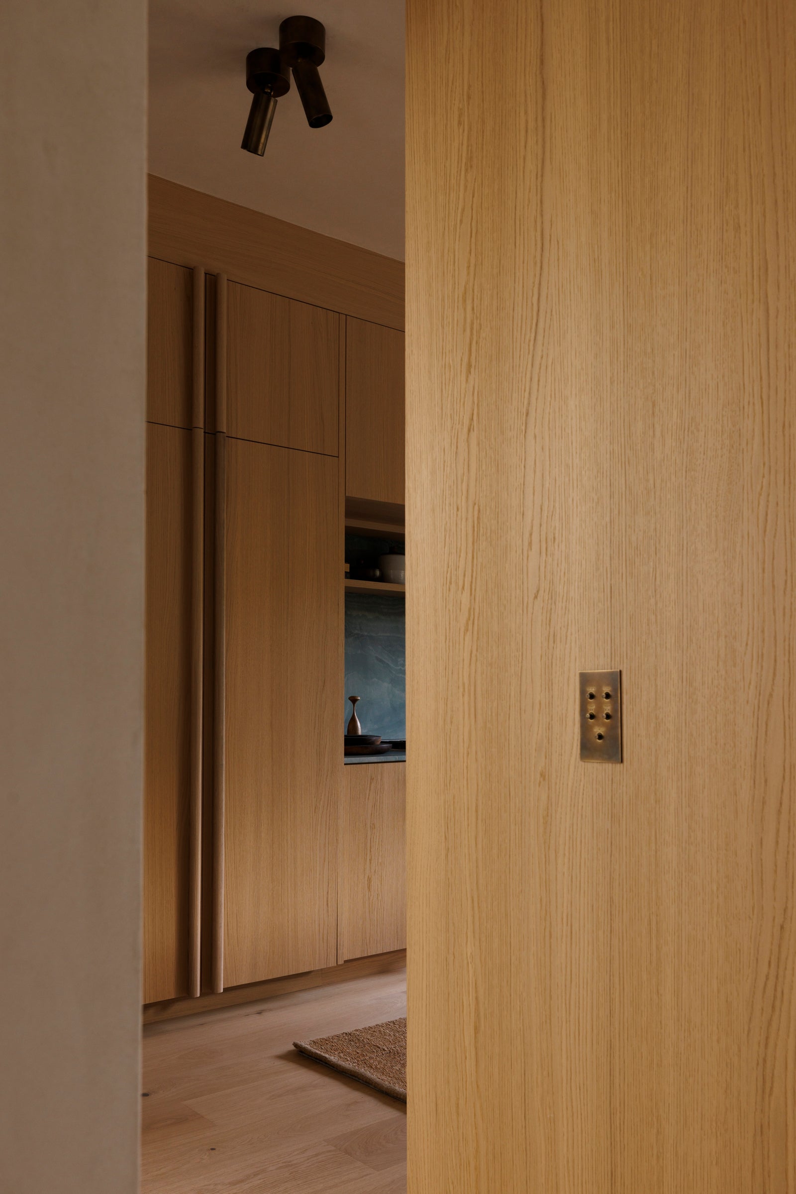 Close-up of MADERA's precision oak millwork reveals the quality grain and expert joinery in every custom panel.