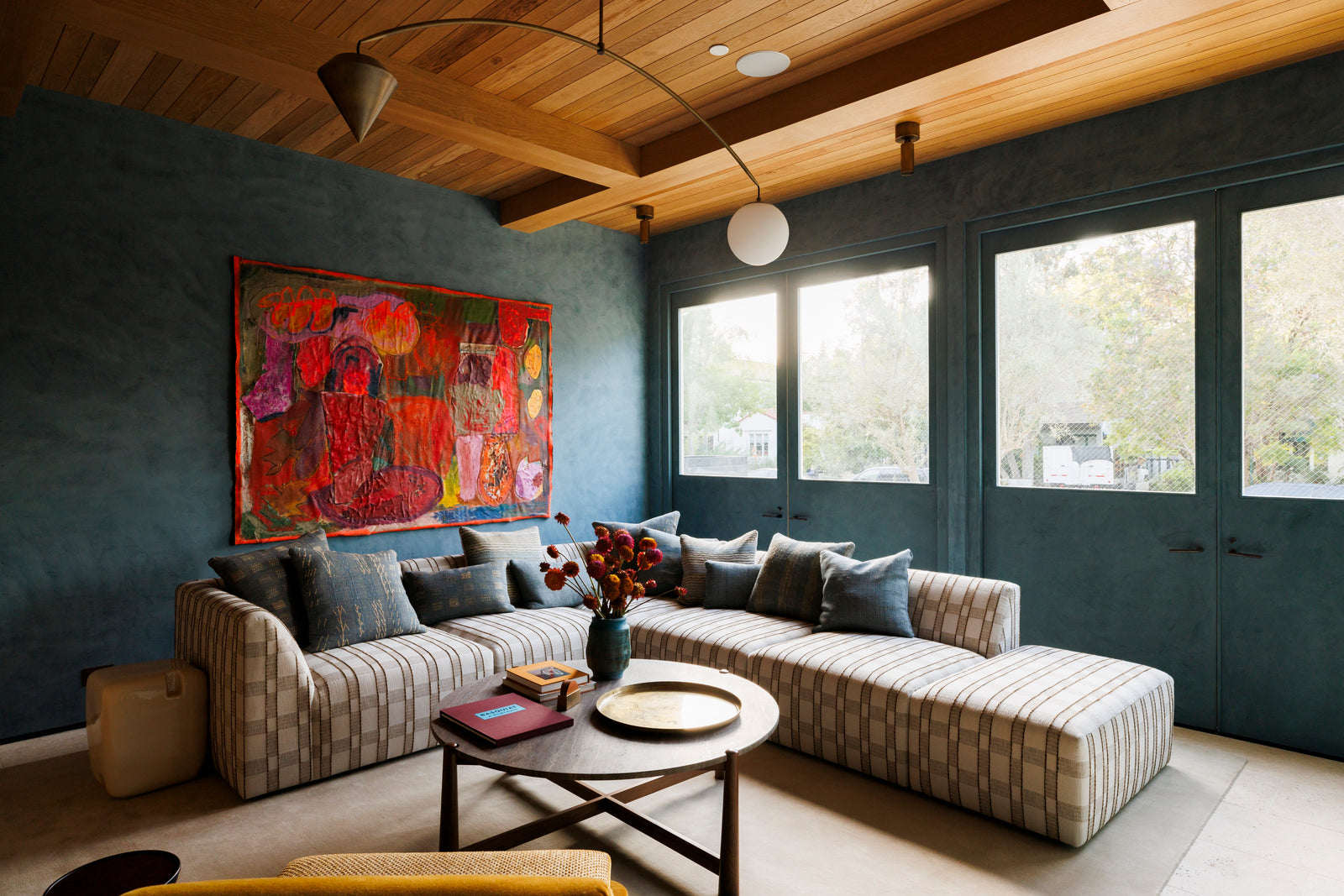 MADERA's stunning wood plank ceiling brings architectural drama and natural character to this jewel-toned lounge
