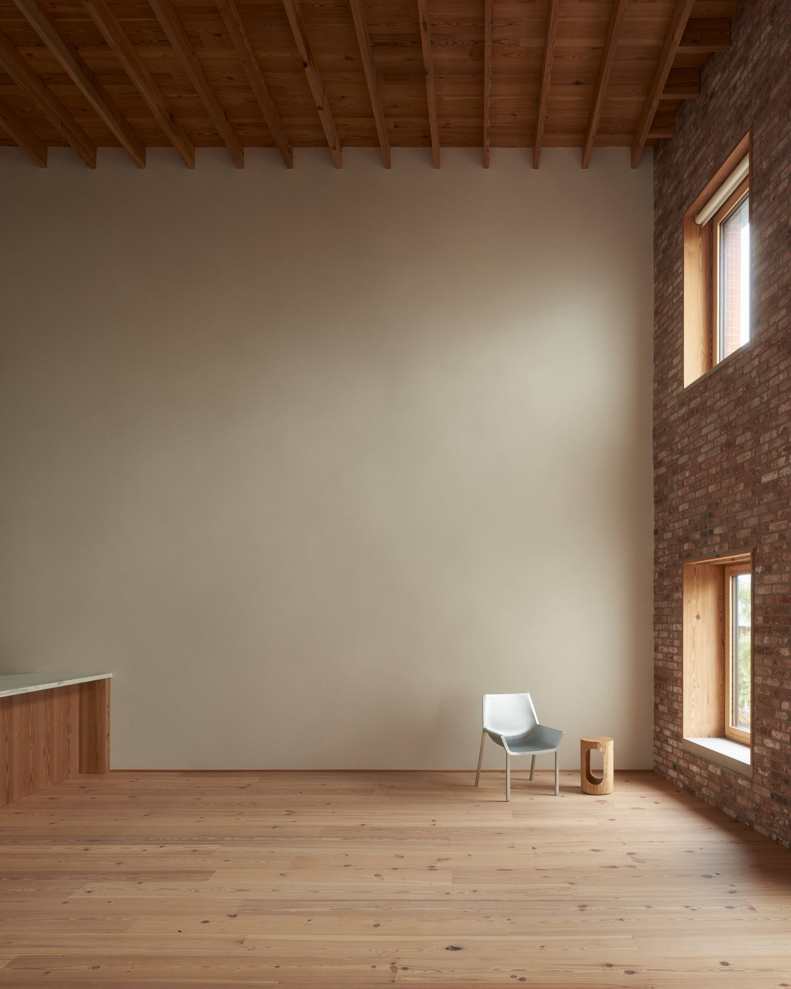 The interplay of raw brick and warm wood ceiling creates a tactile dialogue between Williamsburg's industrial past and contemporary comfort.