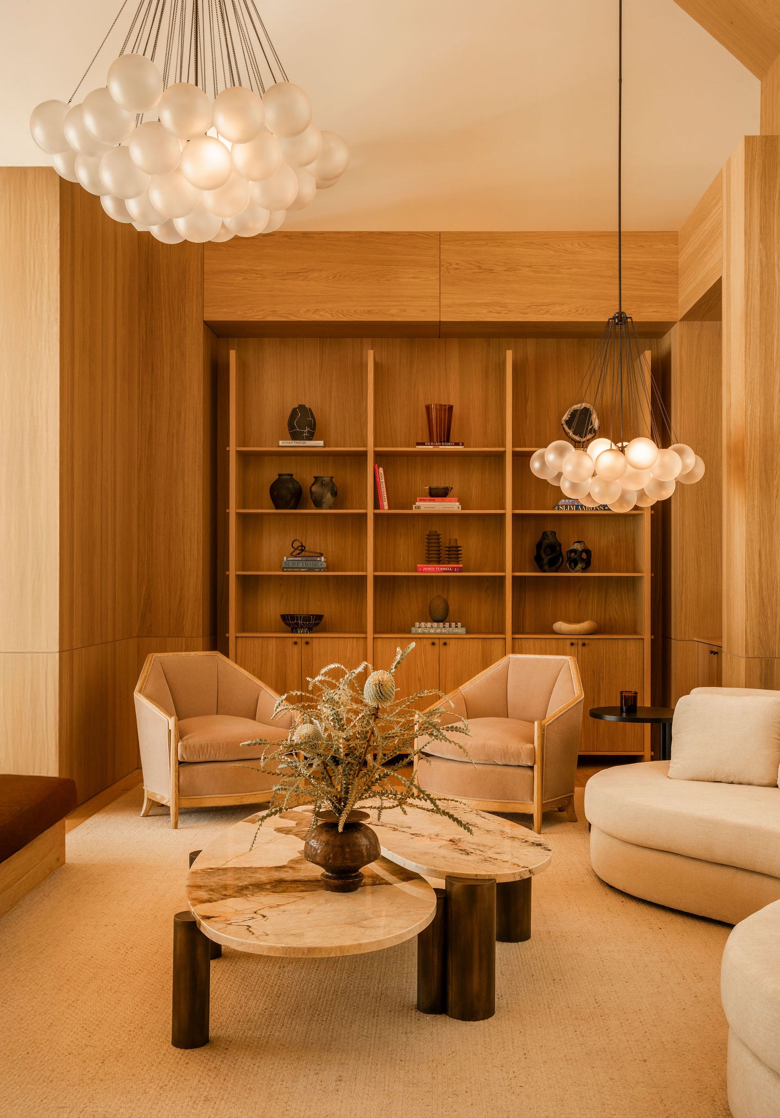 Warm oak built-ins and architectural detailing showcase MADERA's craftsmanship in this contemporary seating area.