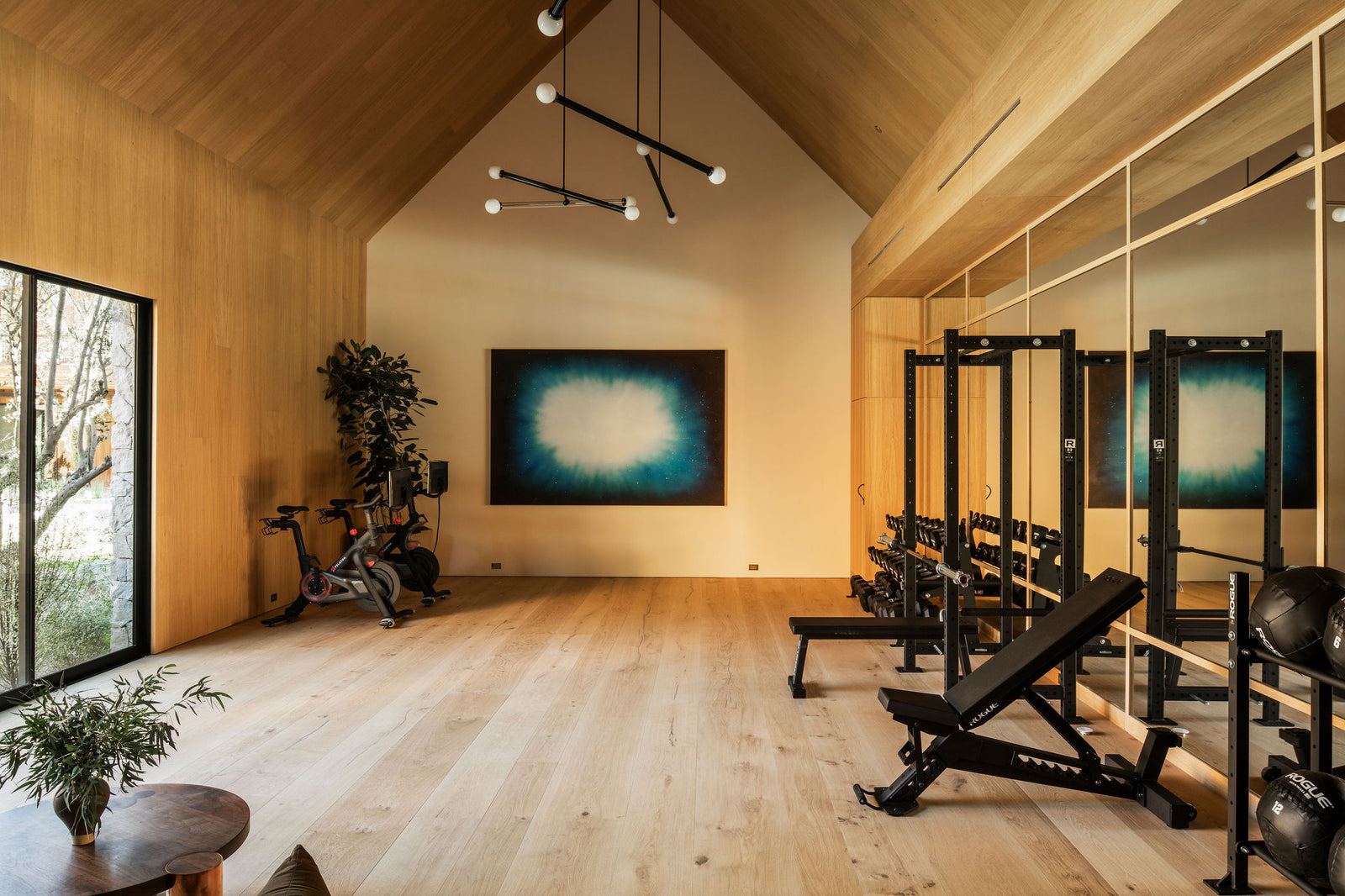 Clean lines and natural oak finishes highlight MADERA's ability to transform functional spaces like this light-filled home gym.