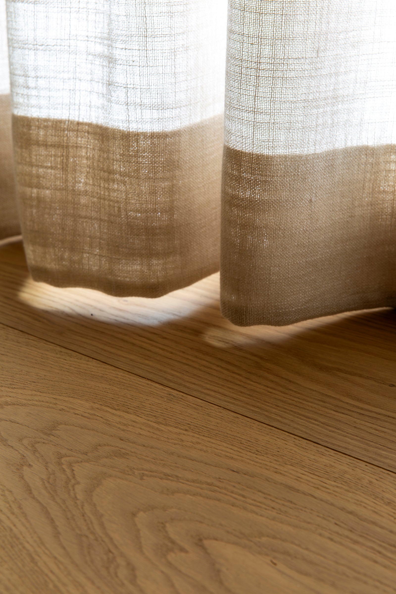 Close-up detail of MADERA's smoked European oak flooring reveals the natural oxidized oil finish and soft matte texture.