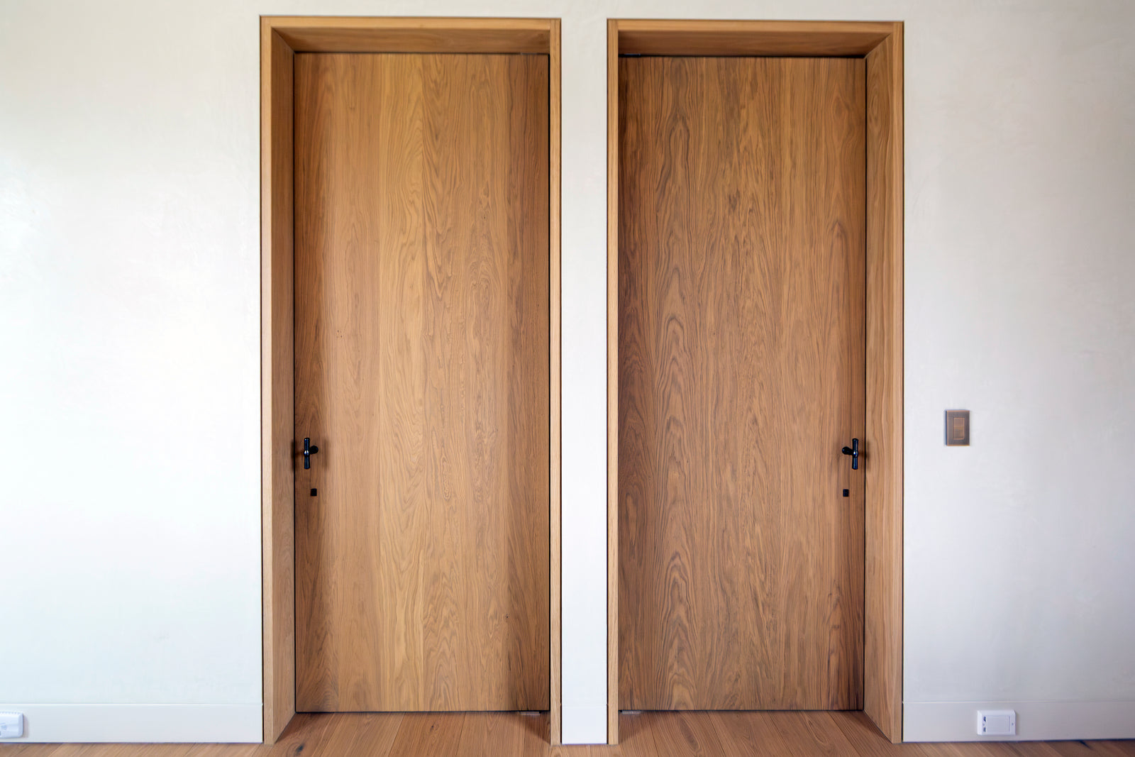 Matching smoked European oak door pairs by MADERA demonstrate the consistency and quality of Seamless Wood Design® throughout.