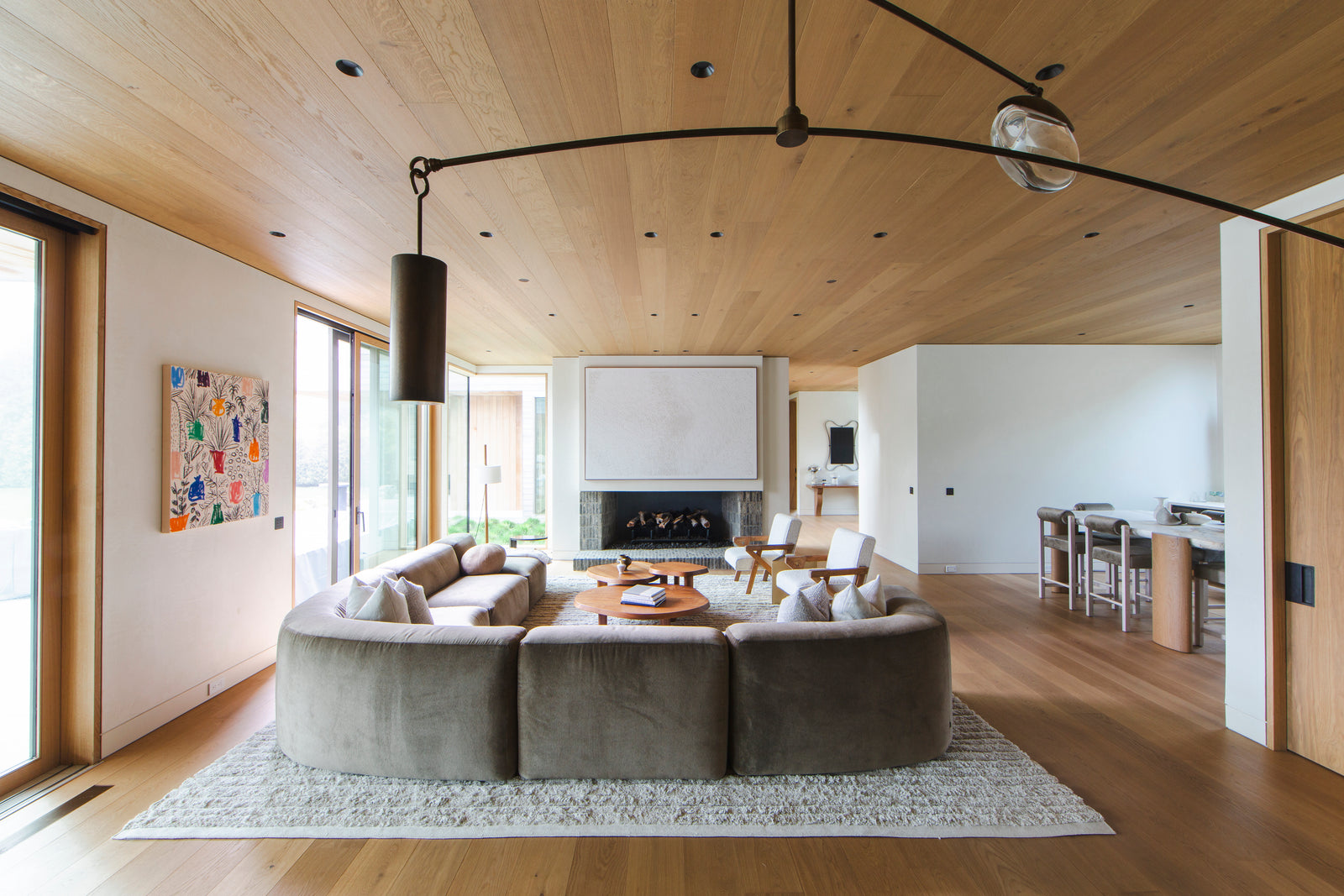 MADERA's wide-plank smoked European oak ceiling and flooring create visual continuity in this open-concept living area.