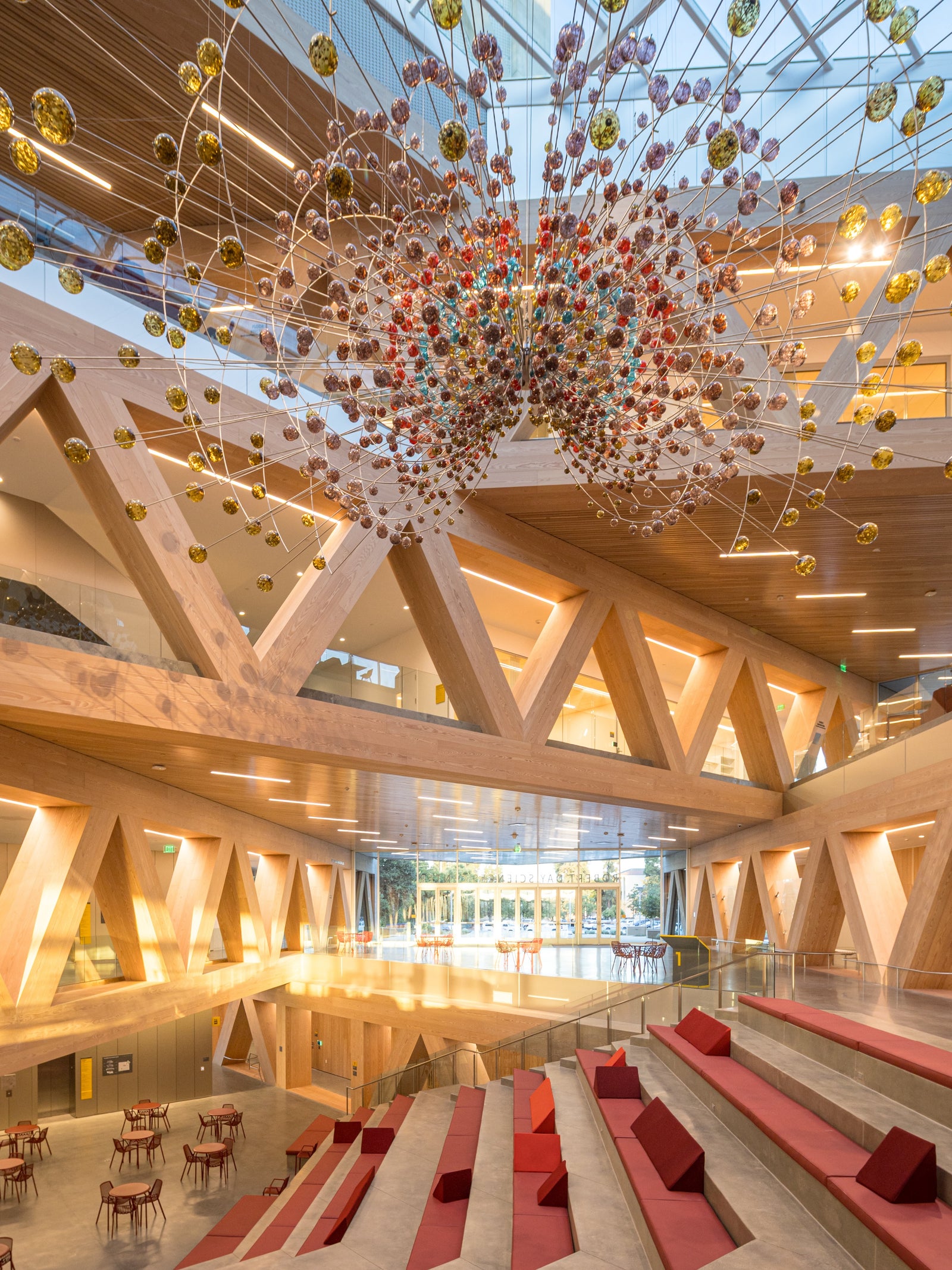 Massive trusses clad in MADERA’s Douglas Fir frame this multi-level gathering space with striking architectural presence.